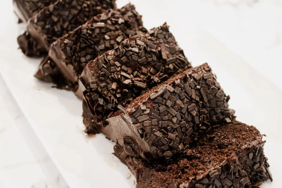 Slices of chocolate cake covered in chocolate shavings