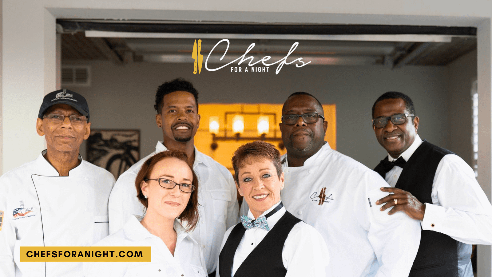 The Chefs for a Night team: six people in chef whites and server vests, smiling in a dining room